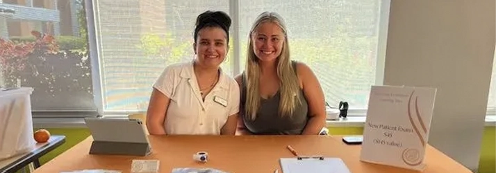Chiropractor Kenosha WI Dianna Bindelli with staff Dr. Dianna Bindelli in a table with other member of the staff