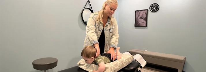 Dianna Bindelli Adjusts an Infant