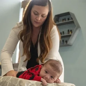 Dr. DoniBeth Davis doing chiropractic technique in a baby